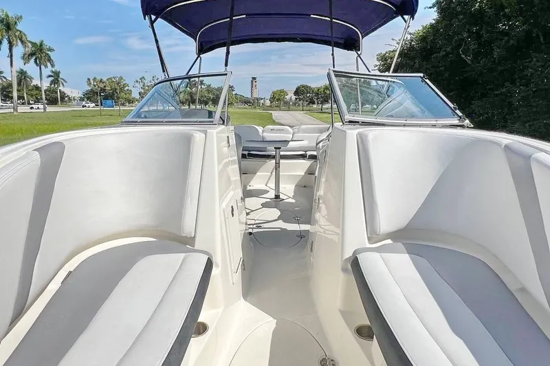 Slide: The Image of 2013 Larson LXi 292 IO boat interior with seating and canopy. - 13