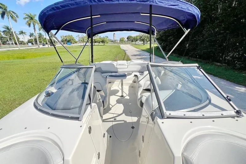 Slide: The Image of 2013 Larson LXi 292 IO boat with blue canopy and spacious seating. - 14