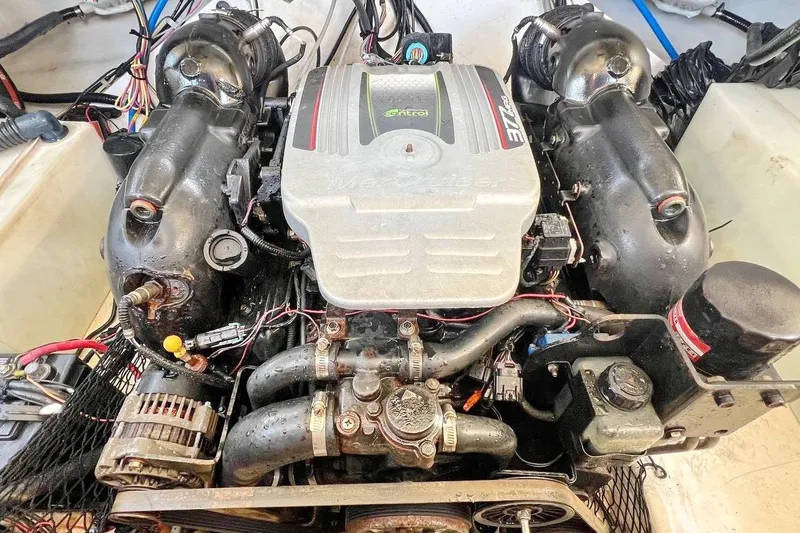 Slide: The Image of 2013 Larson LXi 292 IO boat engine, detailed view of MerCruiser components. - 18