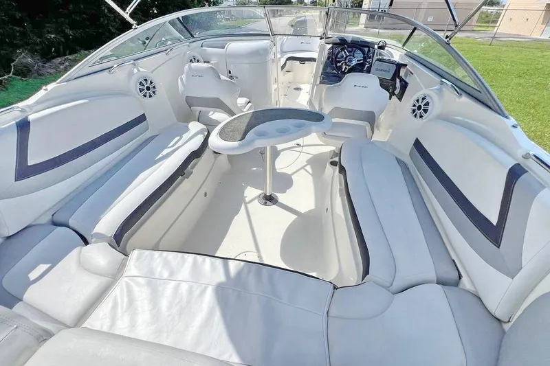 Slide: The Image of 2013 Larson LXi 292 IO boat interior with white seating and steering console. - 8