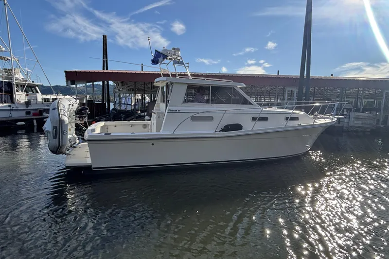 The Image of 1997 Norstar 301 boat docked at marina under clear blue sky. - 0