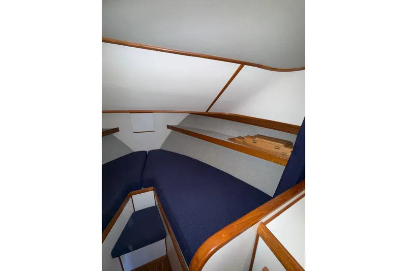 Slide: The Image of Interior cabin of 1997 Norstar 301 boat with blue cushions and wooden trim. - 10