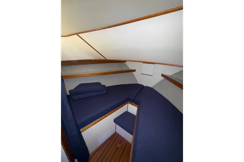 Slide: The Image of Interior cabin of 1997 Norstar 301 boat with blue cushions and wooden accents. - 11