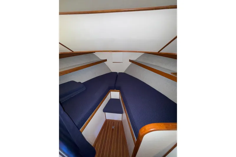Slide: The Image of Interior of 1997 Norstar 301 boat with blue seating and wooden accents. - 12