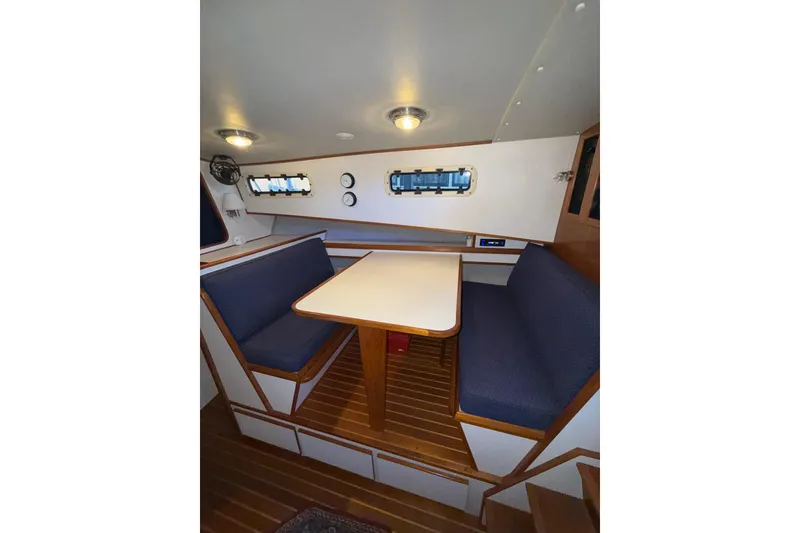 Slide: The Image of Cozy 1997 Norstar 301 boat interior with blue seating and wooden accents. - 15