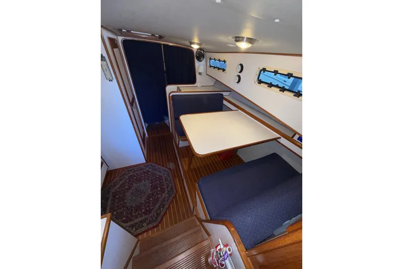 Slide: The Image of Interior of 1997 Norstar 301 boat with dining area and wooden flooring. - 20