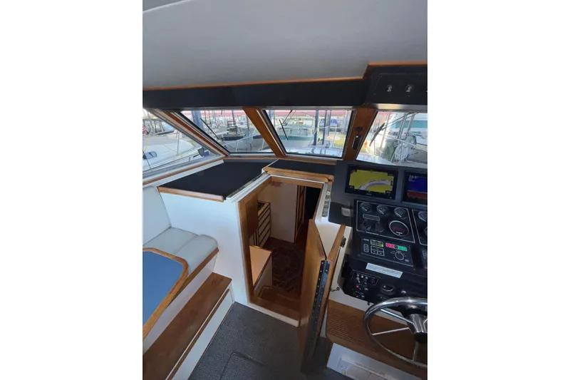 Slide: The Image of Interior view of 1997 Norstar 301 boat cockpit with navigation controls. - 25