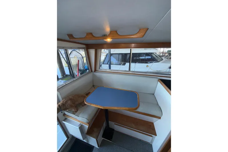Slide: The Image of 1997 Norstar 301 boat interior with dining area and windows. - 26
