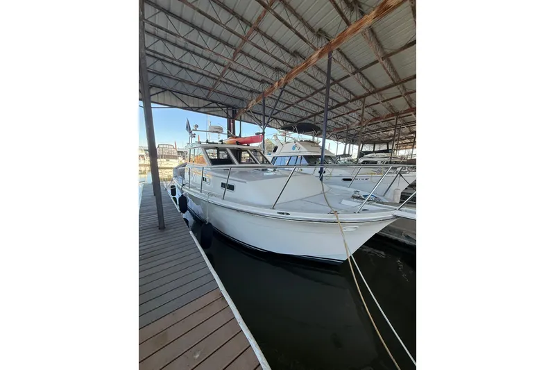 Slide: The Image of 1997 Norstar 301 boat docked in a covered marina. - 33