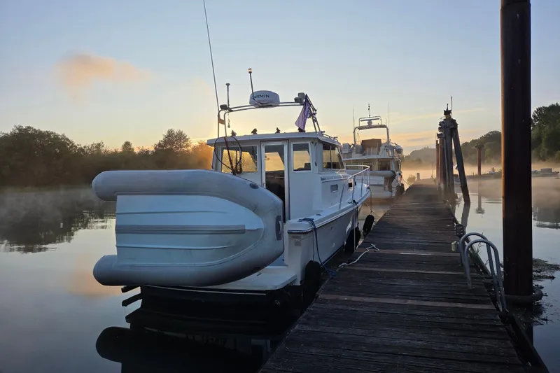 Slide: The Image of Docked 1997 Norstar 301 boat at sunrise with misty water and wooden pier. - 36