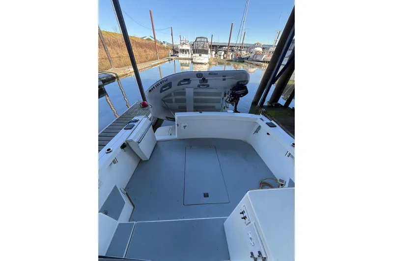 Slide: The Image of 1997 Norstar 301 boat interior at a marina, showcasing spacious deck and seating area. - 4