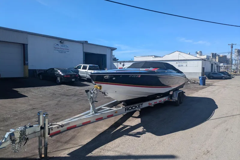 Slide: The Image of 2008 Formula 292 FASTech boat on trailer outside a marine service facility. - 2