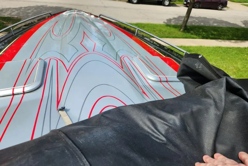 Slide: The Image of 2008 Formula 292 FASTech boat with sleek red and gray design, partially covered. - 4