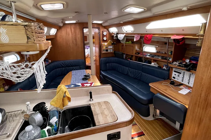 Slide: The Image of Interior of a 2001 Catalina 380 sailboat with cozy seating and wooden accents. - 10
