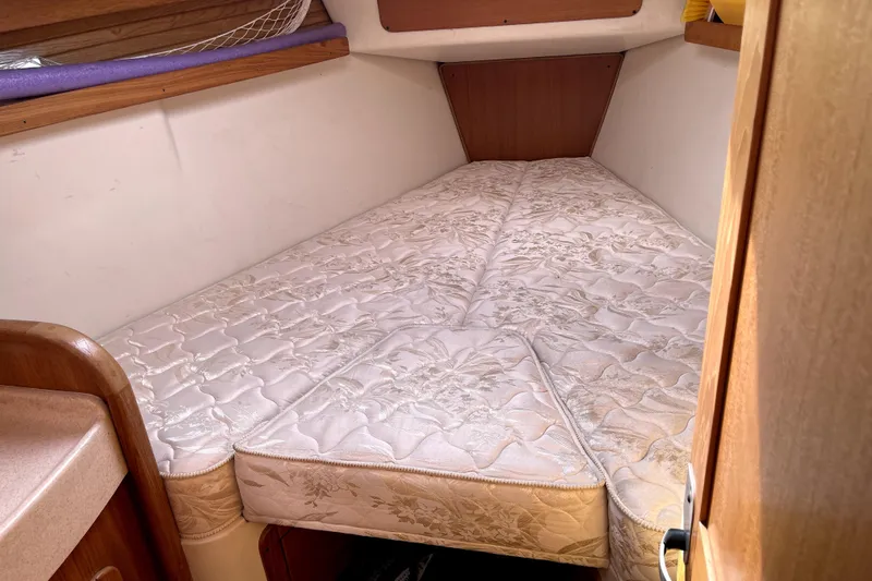 Slide: The Image of Cozy cabin bed in a 2001 Catalina 380 sailboat, featuring a comfortable mattress. - 13