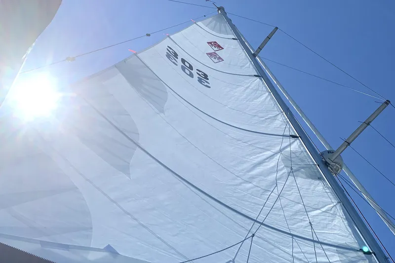 Slide: The Image of Sail of a 2001 Catalina 380 yacht against a bright blue sky. - 2