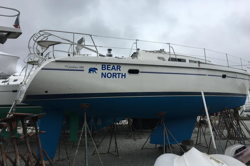 Slide: The Image of Catalina 380 sailboat, 2001 model, named "Bear North," on stands in a boatyard. - 3