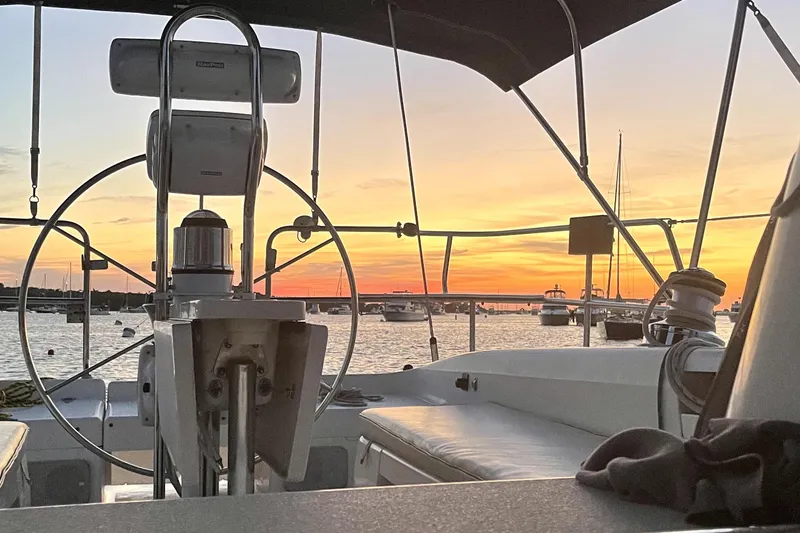 Slide: The Image of Cockpit view of 2001 Catalina 380 sailboat at sunset in a marina. - 9
