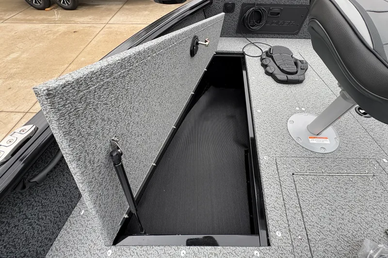 Slide: The Image of Open storage compartment in 2026 Lund 1700 Explorer SS boat interior. - 11