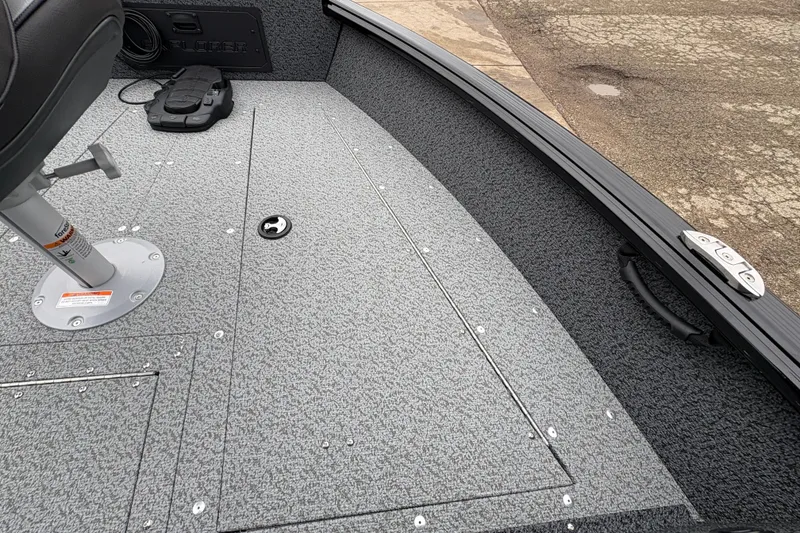 Slide: The Image of 2026 Lund 1700 Explorer SS boat interior with textured flooring and seat base. - 12