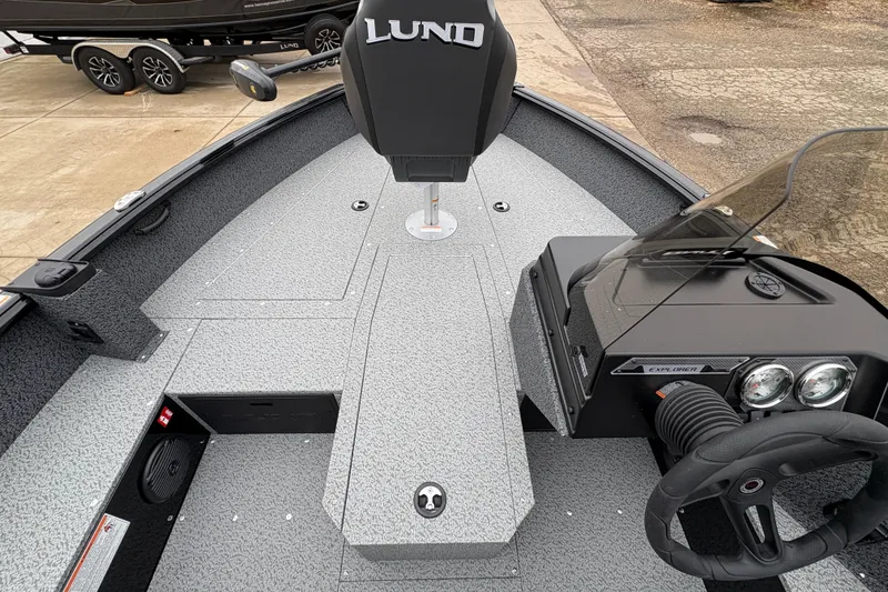 Slide: The Image of 2026 Lund 1700 Explorer SS boat interior with steering console and seating. - 15