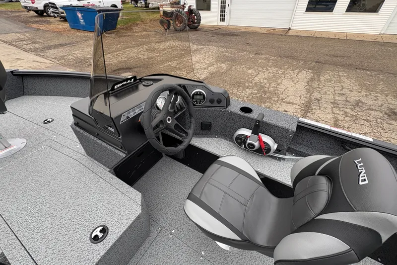 Slide: The Image of 2026 Lund 1700 Explorer SS boat interior with steering wheel and control panel. - 18