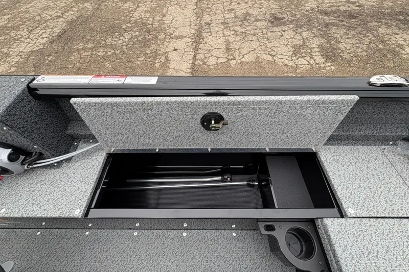 Slide: The Image of 2026 Lund 1700 Explorer SS boat storage compartment with textured interior and secure latch. - 22