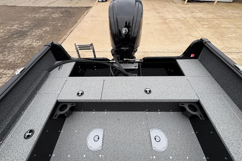 Slide: The Image of 2026 Lund 1700 Explorer SS boat interior with motor and storage compartments. - 23