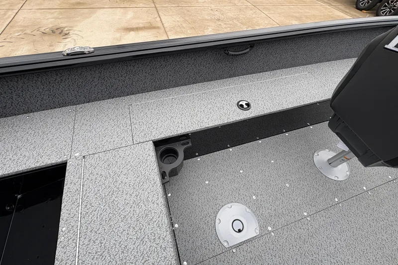 Slide: The Image of 2026 Lund 1700 Explorer SS boat interior with gray textured flooring and seating. - 26
