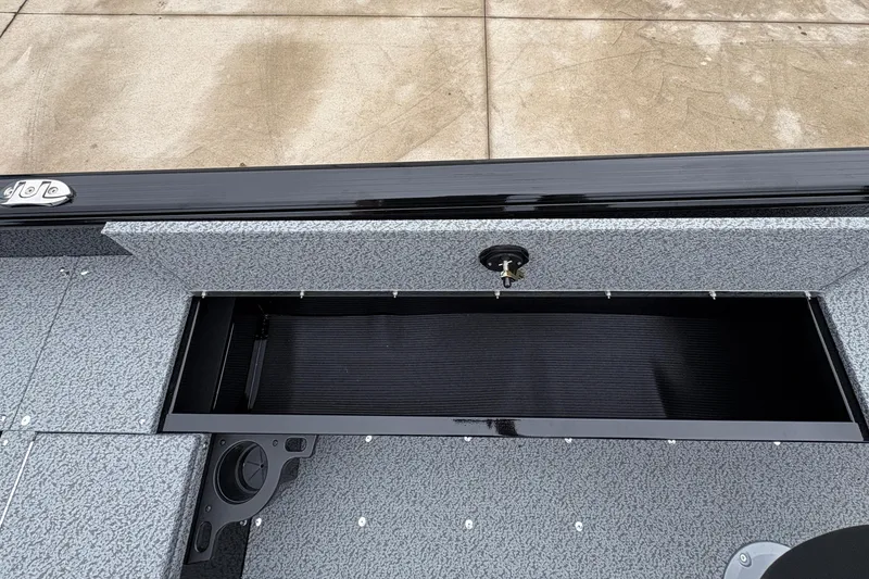 Slide: The Image of 2026 Lund 1700 Explorer SS boat storage compartment with textured interior and secure latch. - 27