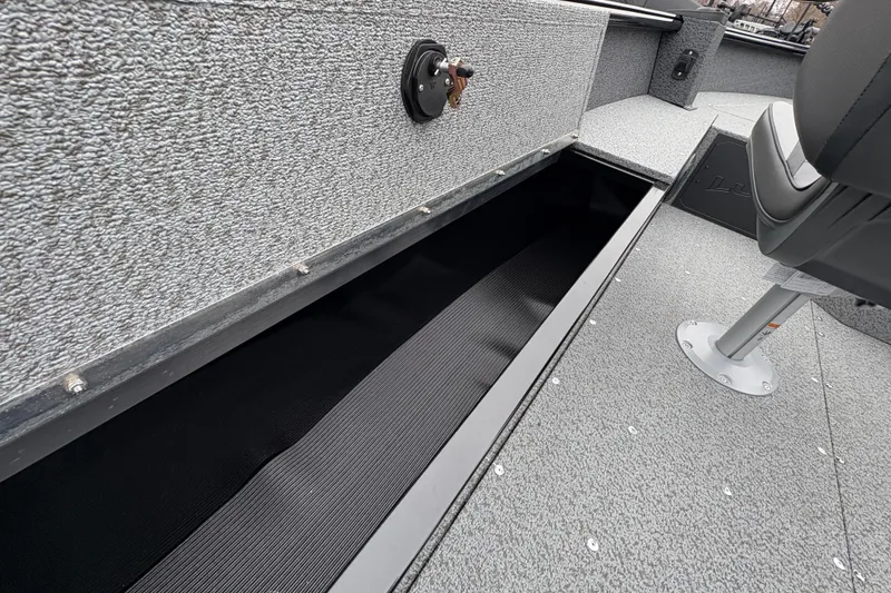 Slide: The Image of 2026 Lund 1700 Explorer SS boat interior with open storage compartment and seating. - 28