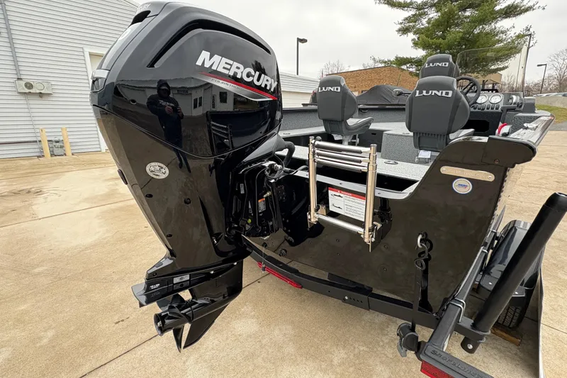 Slide: The Image of 2026 Lund 1700 Explorer SS boat with Mercury outboard motor, parked on concrete. - 31