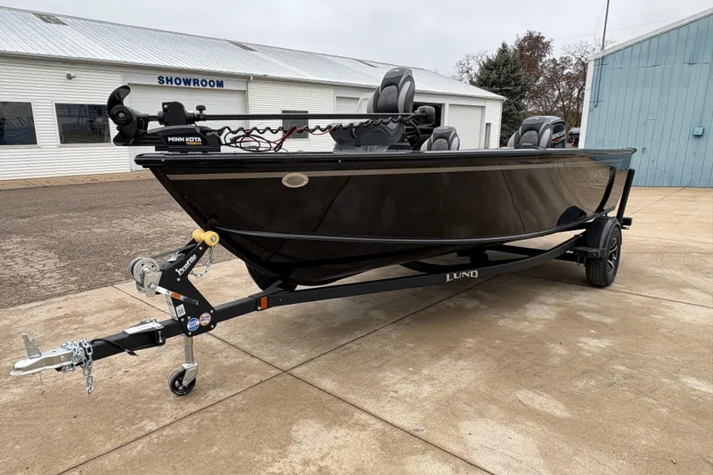 Slide: The Image of 2026 Lund 1700 Explorer SS boat on trailer outside showroom. - 5