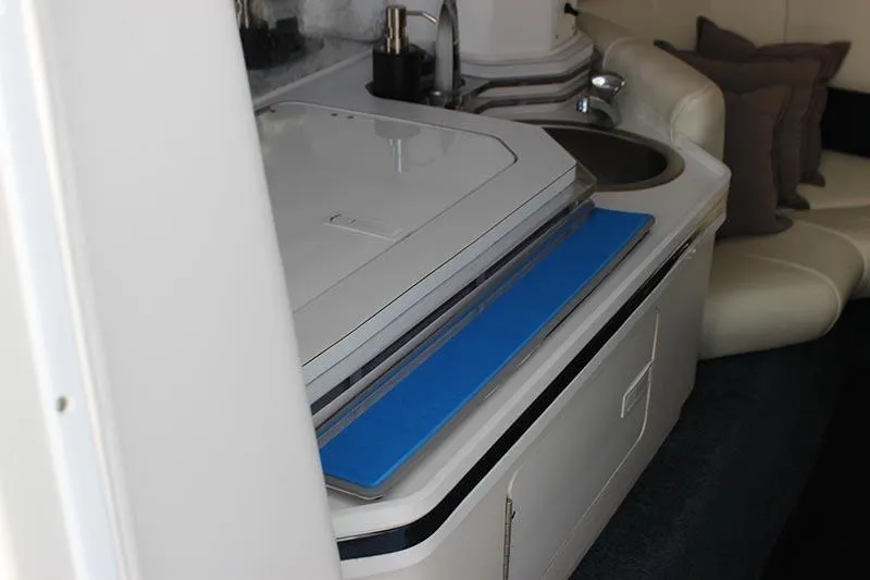 Slide: The Image of Interior of a 2000 Fountain 32 Fever boat with kitchenette and seating area. - 11