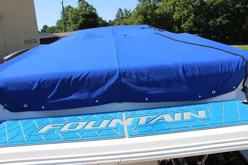 Slide: The Image of 2000 Fountain 32 Fever boat with blue cover and logo. - 2