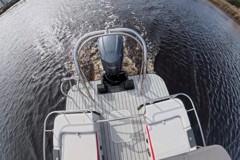 Slide: The Image of 2025 SunCatcher ELITE SERIES 324 SS boat with powerful outboard motor on water. - 11