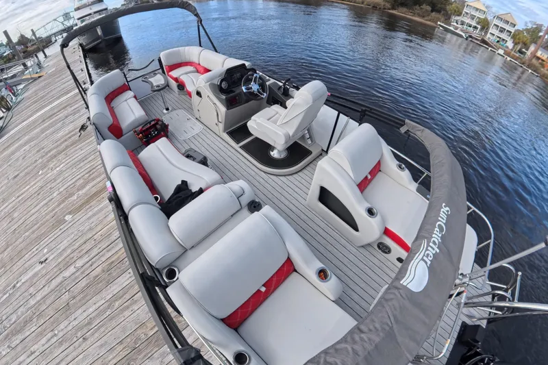 Slide: The Image of 2025 SunCatcher ELITE SERIES 324 SS pontoon boat docked, featuring spacious seating and modern design. - 13