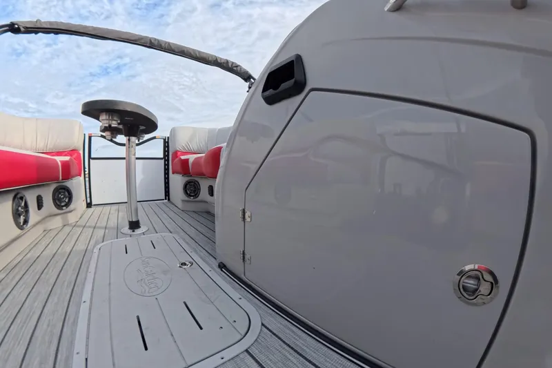 Slide: The Image of 2025 SunCatcher ELITE SERIES 324 SS boat interior with red seating and sleek design. - 22