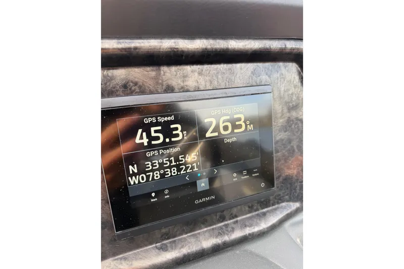 Slide: The Image of Garmin GPS display on 2025 SunCatcher ELITE SERIES 324 SS showing speed and coordinates. - 26