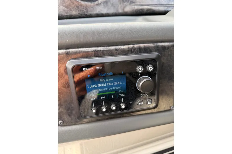 Slide: The Image of 2025 SunCatcher ELITE SERIES 324 SS audio system displaying song details on screen. - 28