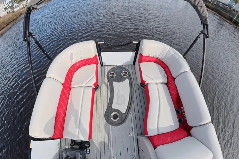 Slide: The Image of Luxurious seating on 2025 SunCatcher ELITE SERIES 324 SS pontoon boat, featuring red and white upholstery. - 8
