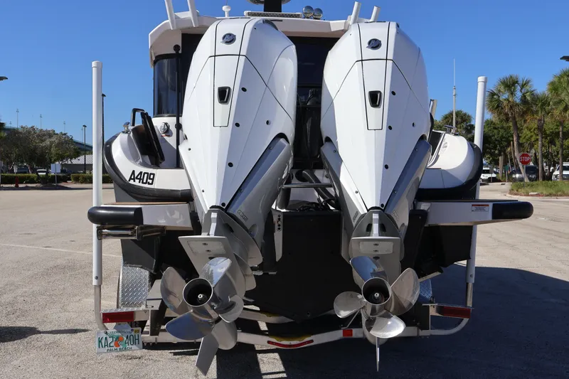 Slide: The Image of 2024 XO Boats EXPLR 10 S Plus with dual outboard engines, rear view. - 14