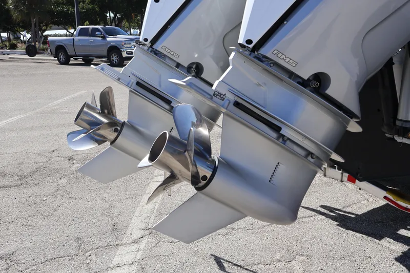 Slide: The Image of 2024 XO Boats EXPLR 10 S Plus outboard motors in a parking lot. - 15