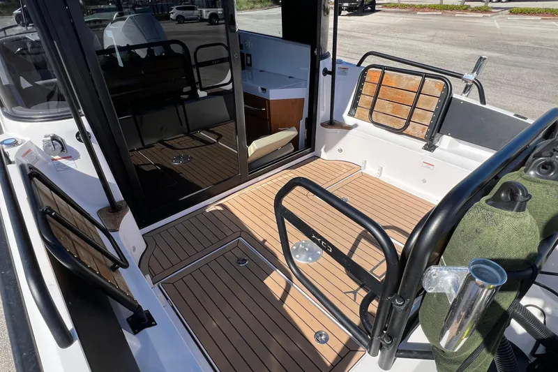 Slide: The Image of 2024 XO Boats EXPLR 10 S Plus interior with sleek wood flooring and modern design. - 19
