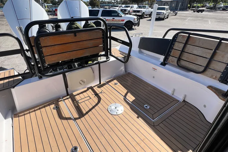 Slide: The Image of 2024 XO Boats EXPLR 10 S Plus deck with wooden seating and modern design. - 21