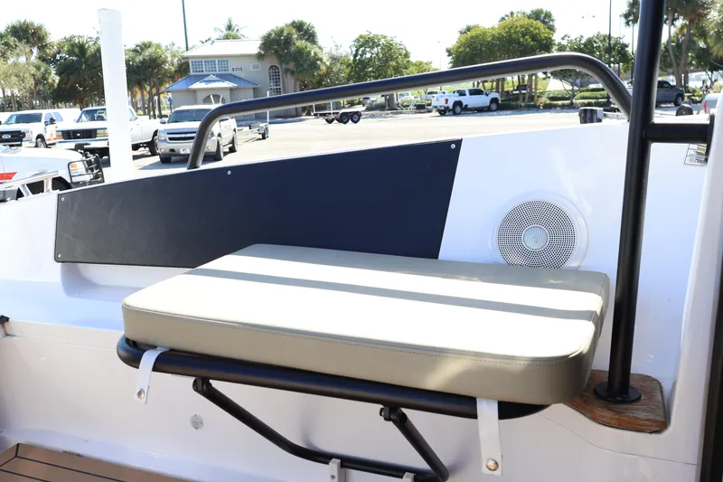 Slide: The Image of 2024 XO Boats EXPLR 10 S Plus seating area with speaker and railing. - 24