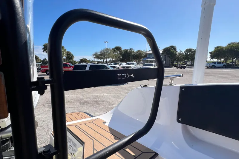 Slide: The Image of 2024 XO Boats EXPLR 10 S Plus, rear view, parked with visible railing and deck. - 25