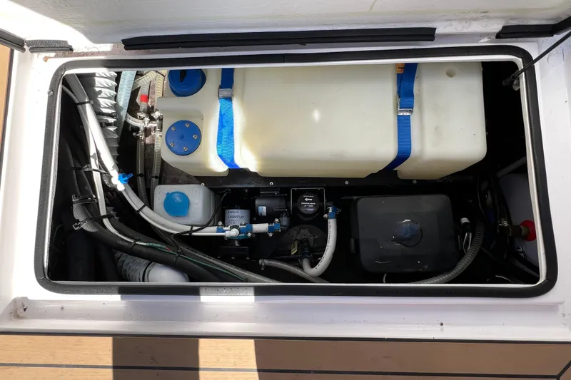 Slide: The Image of 2024 XO Boats EXPLR 10 S Plus engine compartment with visible components and wiring. - 28