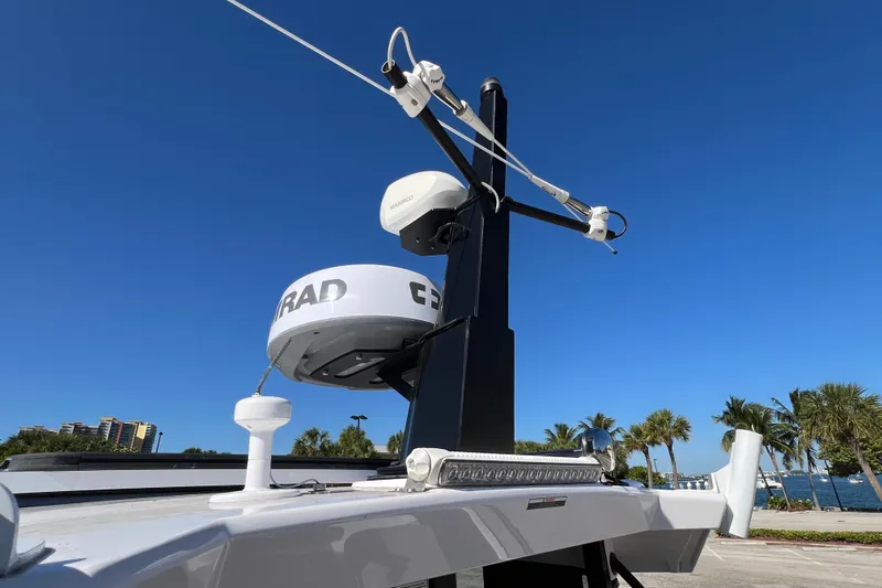 Slide: The Image of 2024 XO Boats EXPLR 10 S Plus radar and antenna system under clear blue sky. - 32