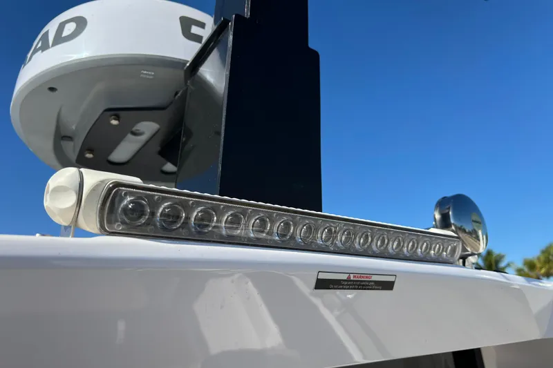 Slide: The Image of 2024 XO Boats EXPLR 10 S Plus radar and light detail against blue sky. - 35